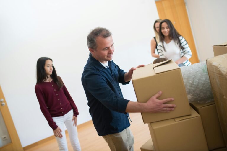A family is arranging boxes for their house move in the concept of moving to Chiswick