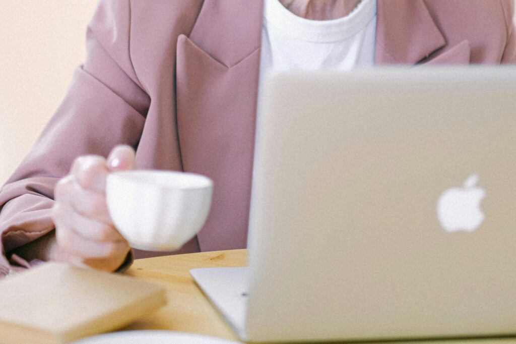 A woman in front of her laptop checking for online reviews.