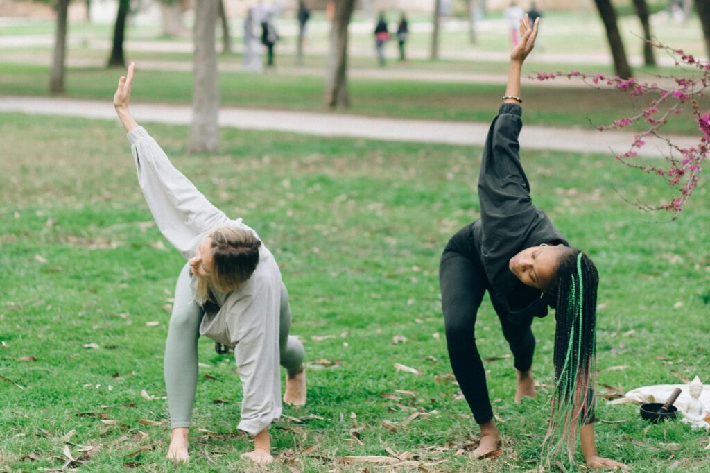 Women doing yoga in a green space