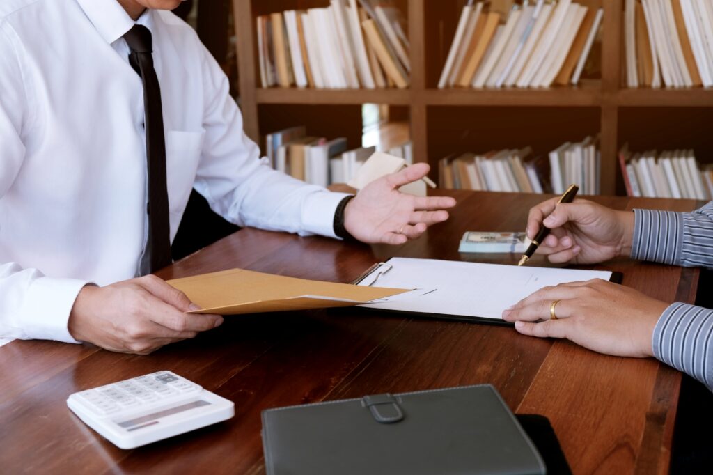A buyer is signing a contract with a real estate agent