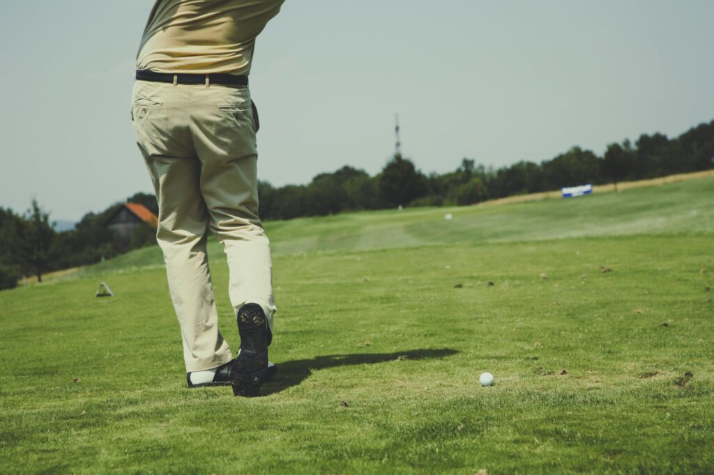 A man on a golf course in the concept of services and amenities in Chiswick.