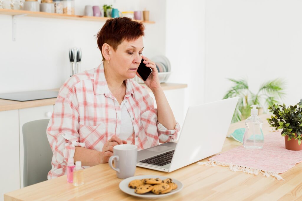 An elderly woman speaking on the phone with a removals company
