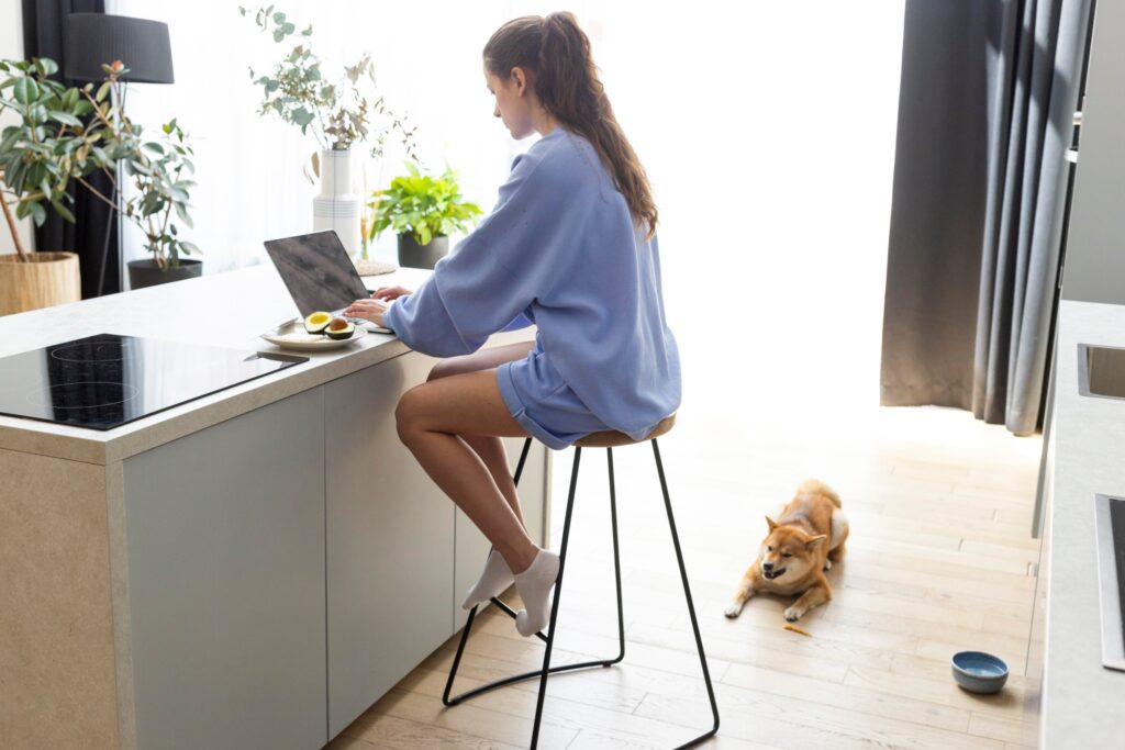 A young woman researching removal companies on her laptop
