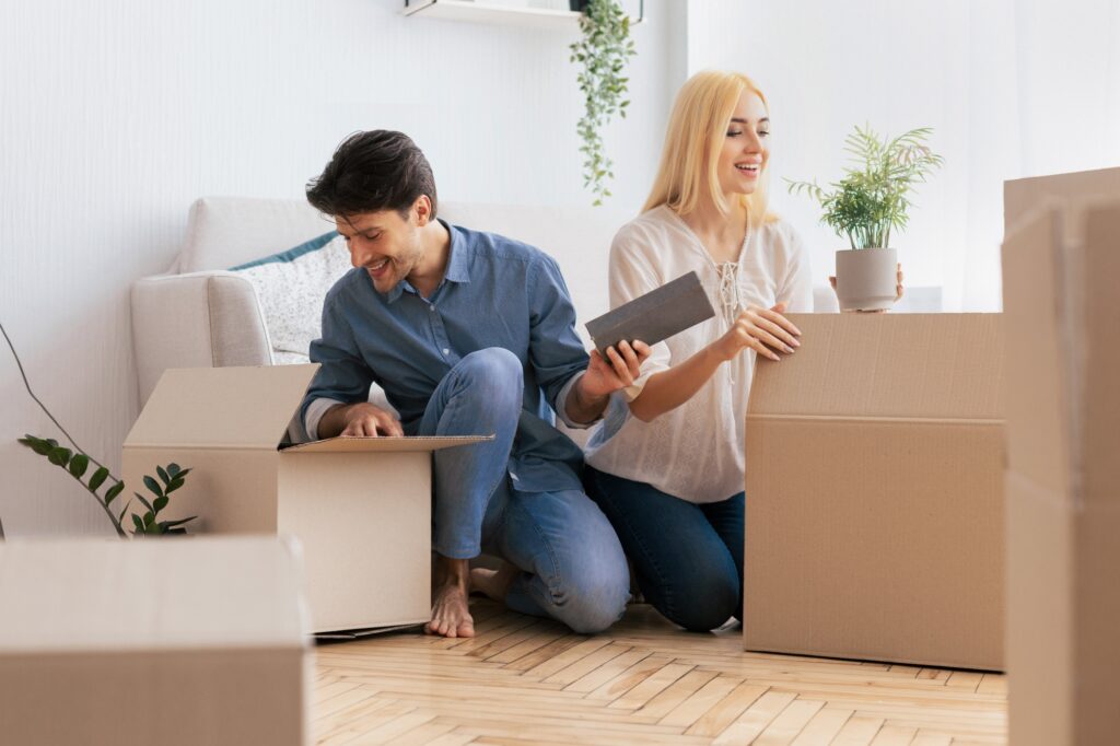 A young couple unpacking in the living room