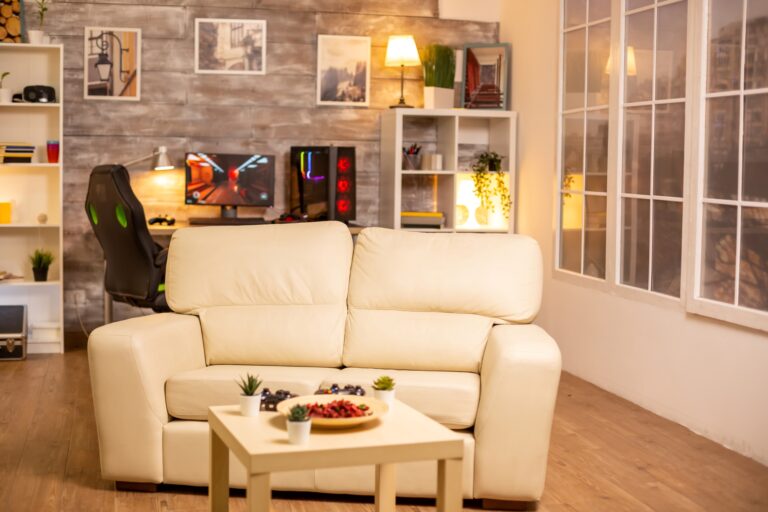 An entertainment room with chairs, tables, desktop, shelves, and other items in the concept of 'How to Pack and Unpack for a Home Removal Efficiently'.
