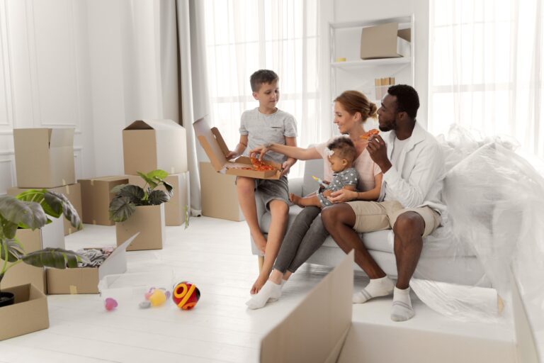 A young family taking a break after packing the living room in the concept of 'How to Pack Household Items Safely for a Move to Chiswick'.