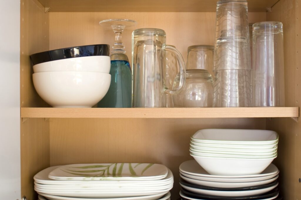 Cropped image of dishes in the cupboard