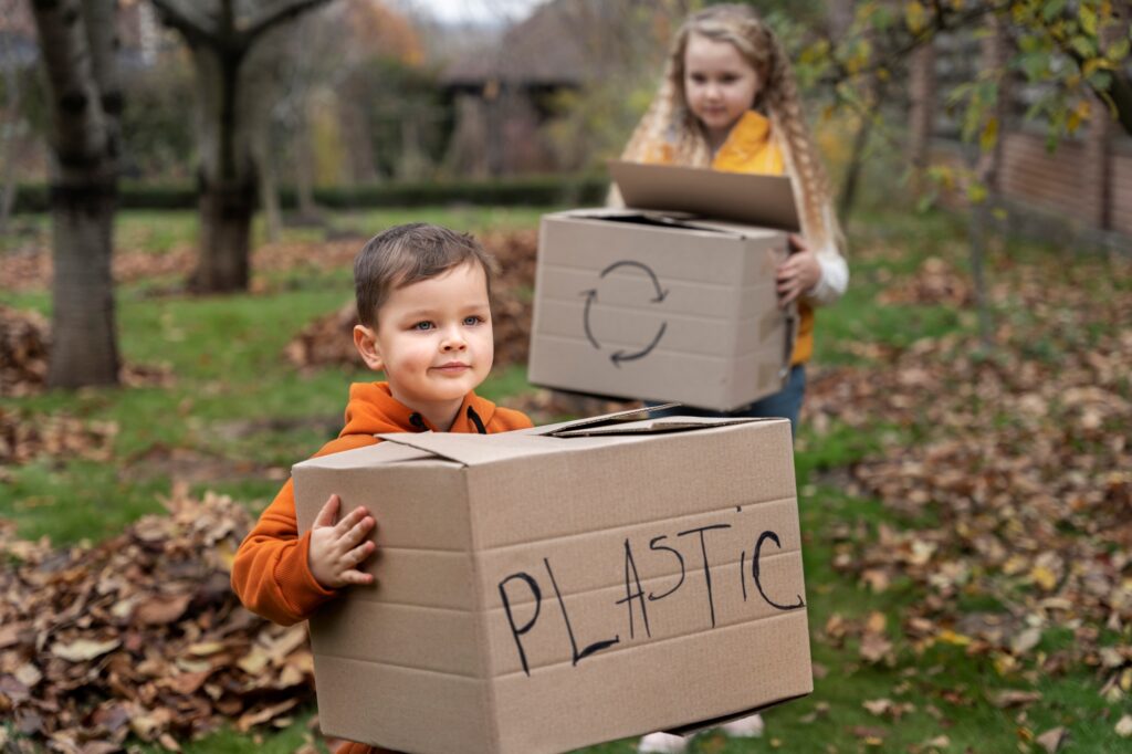 Young children carrying boxes for storing other items
