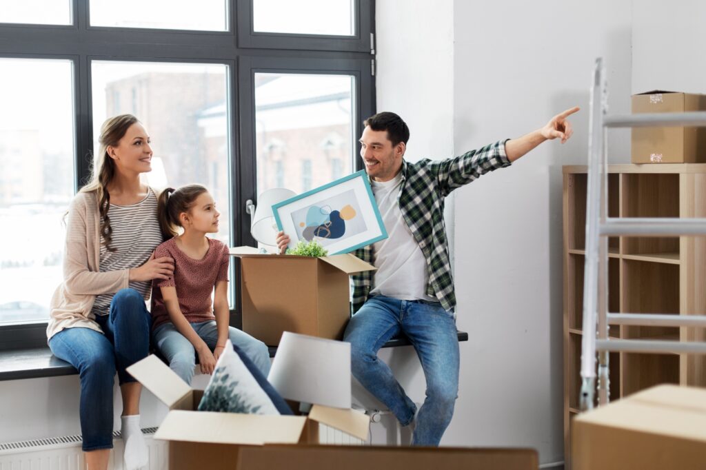 A happy family in their new home starting to settle in (concept of 'How to Settle into a New Home After Moving')