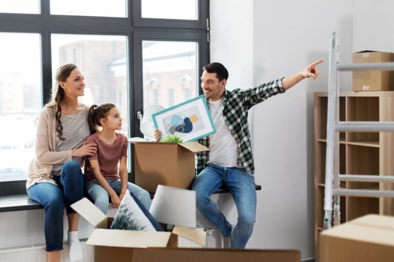 A happy family in their new home starting to settle in (concept of 'How to Settle into a New Home After Moving')
